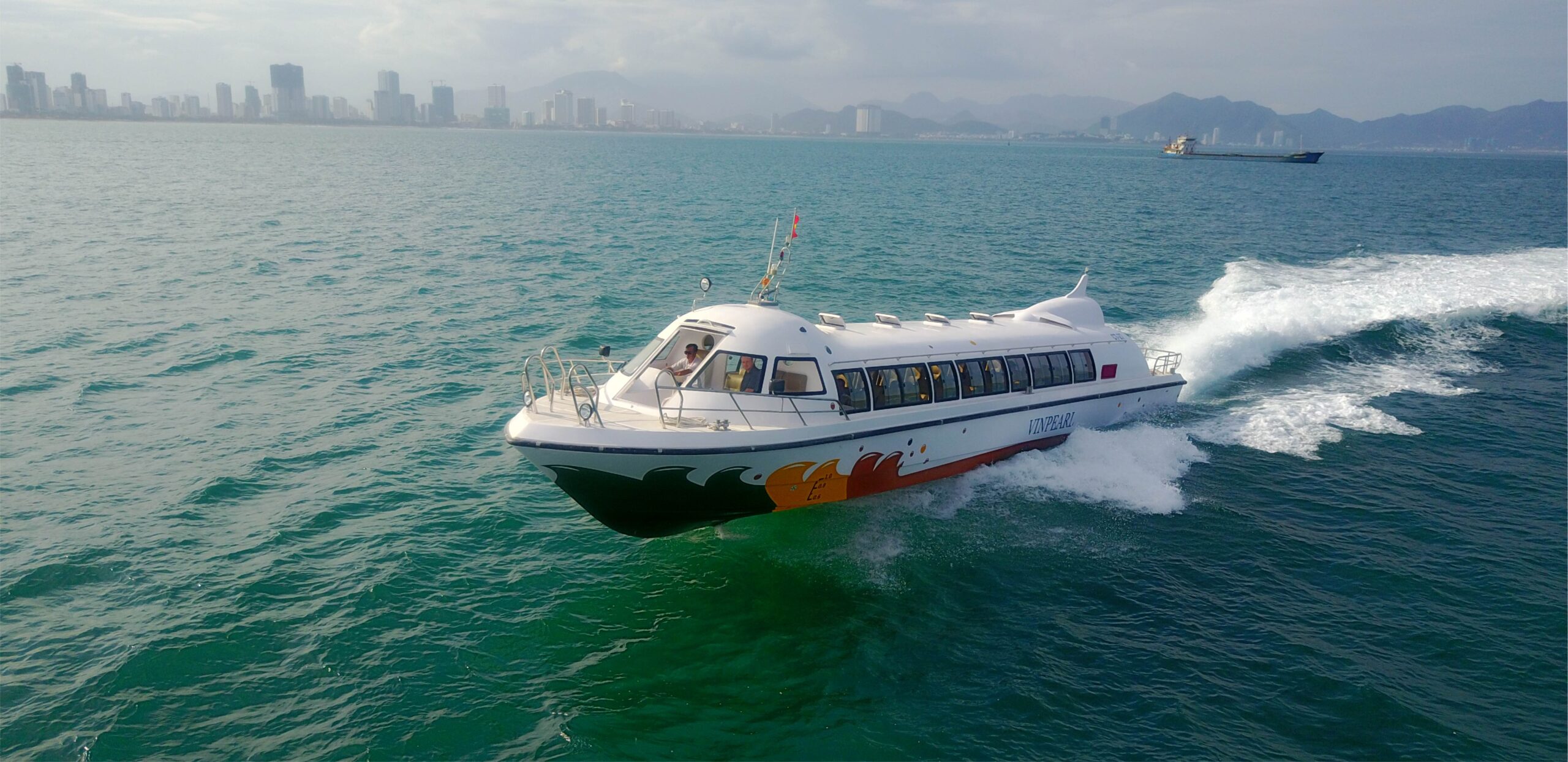 P19 lướt trên vịnh, nền skyline thành phố / P19 cruising across the bay with a city skyline backdrop